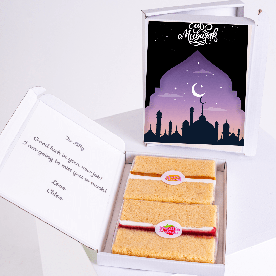 Eid Mubarak gift box with cake, Good luck message, and mosque illustration.