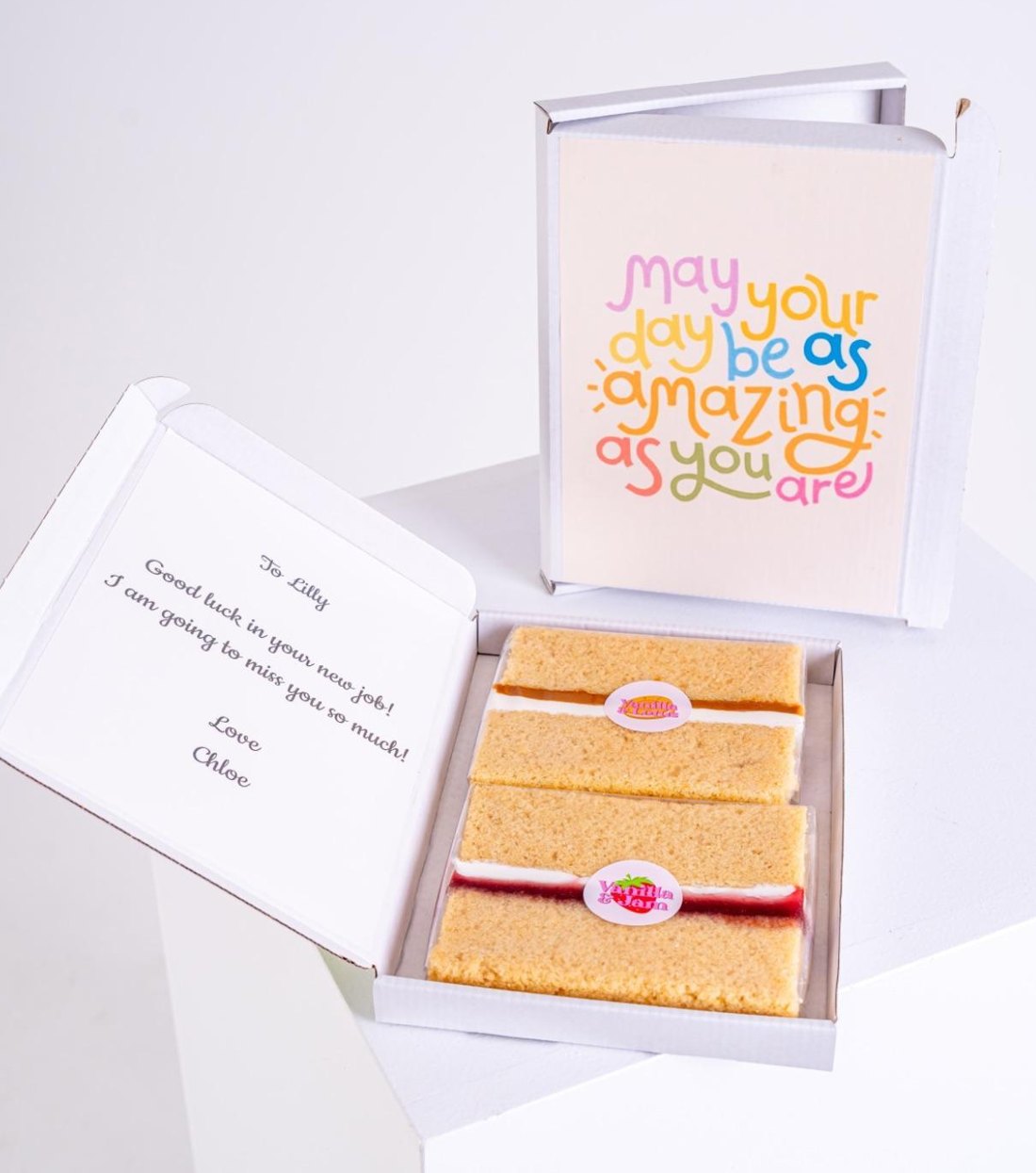 An open MailBakes cake card with cake slices and a personalised message
