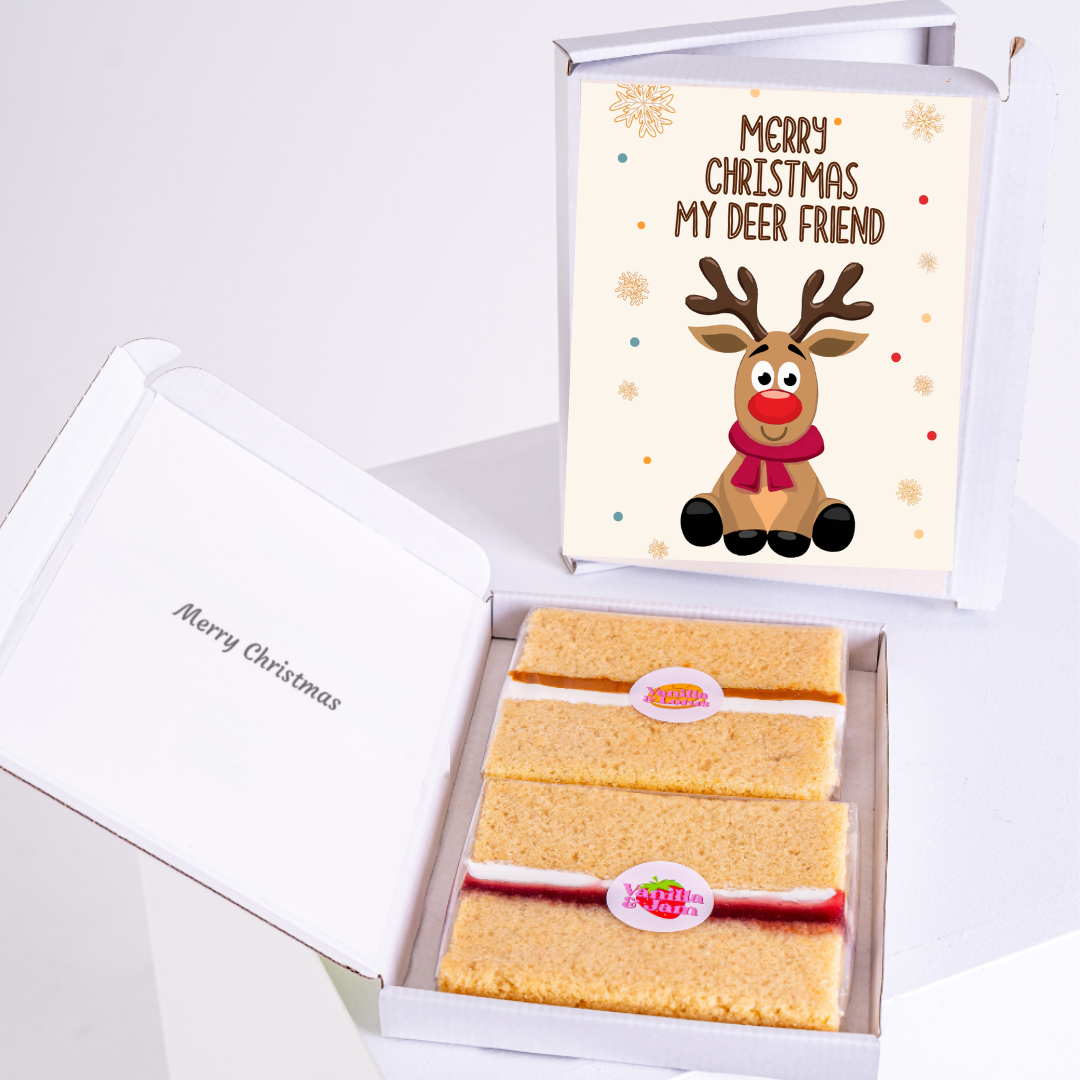 A MailBakes Christmas cake card in its gift box with cake slices inside.