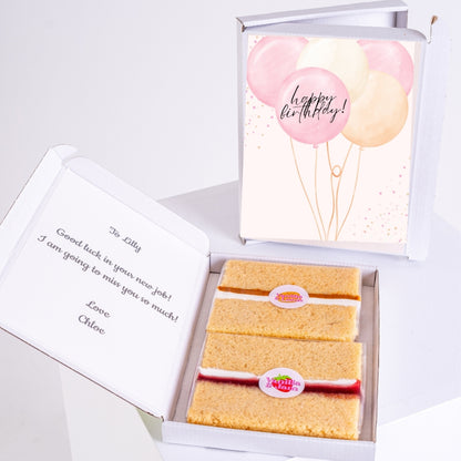 Cake gift box with birthday balloon design inside.