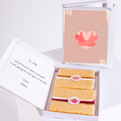 Gift box with cake and a paper hug card for Lilly.
