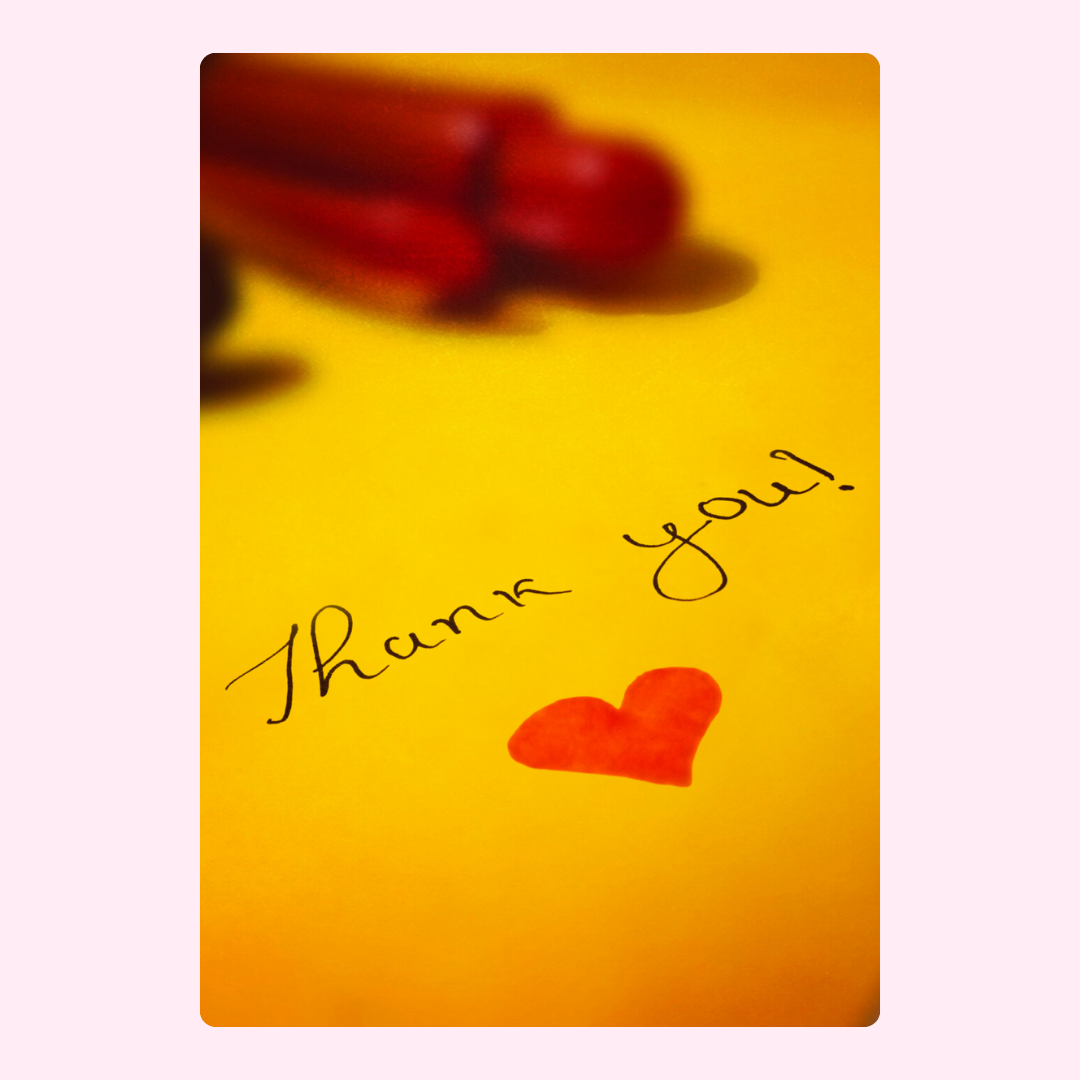 Thank you card with heart and pens on yellow background.