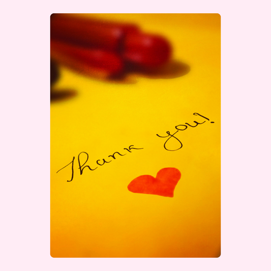 Thank you card with heart and pens on yellow background.