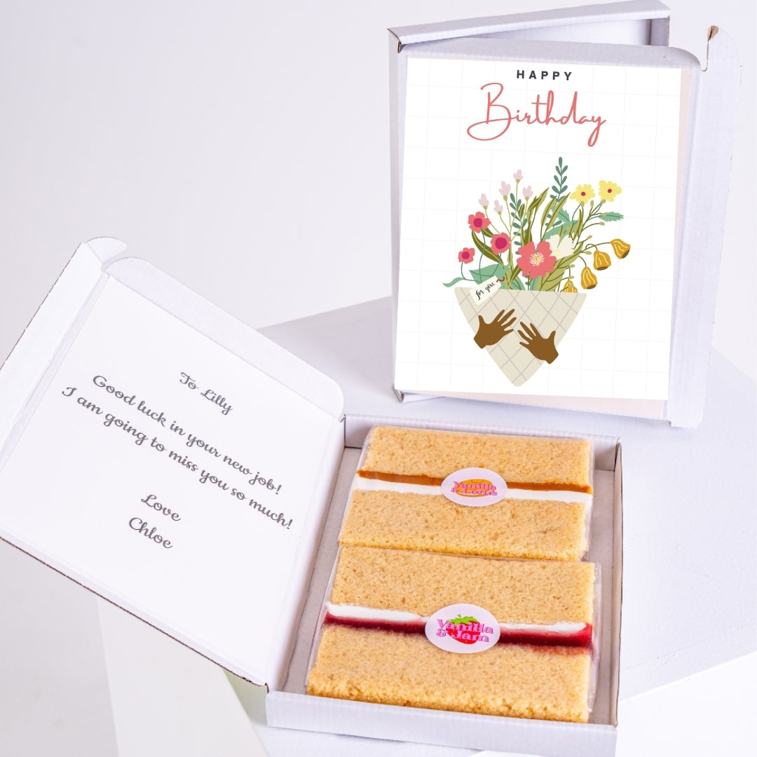 Birthday letterbox cake gift with floral design and message inside.