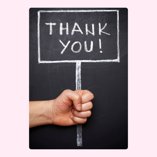 Thank you sign held by hand