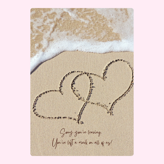 Hearts in sand with wave and message