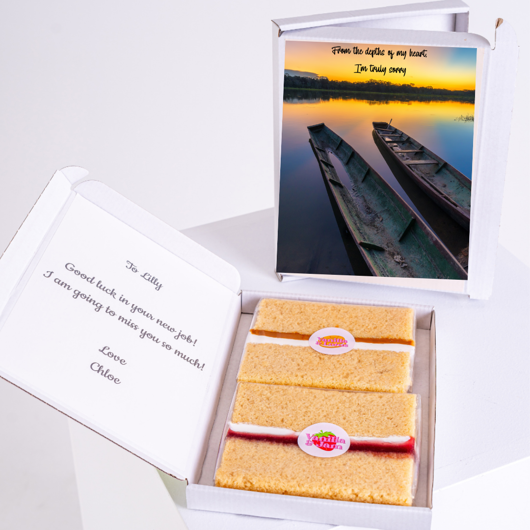 Gift box with cake and a card wishing Lilly good luck.