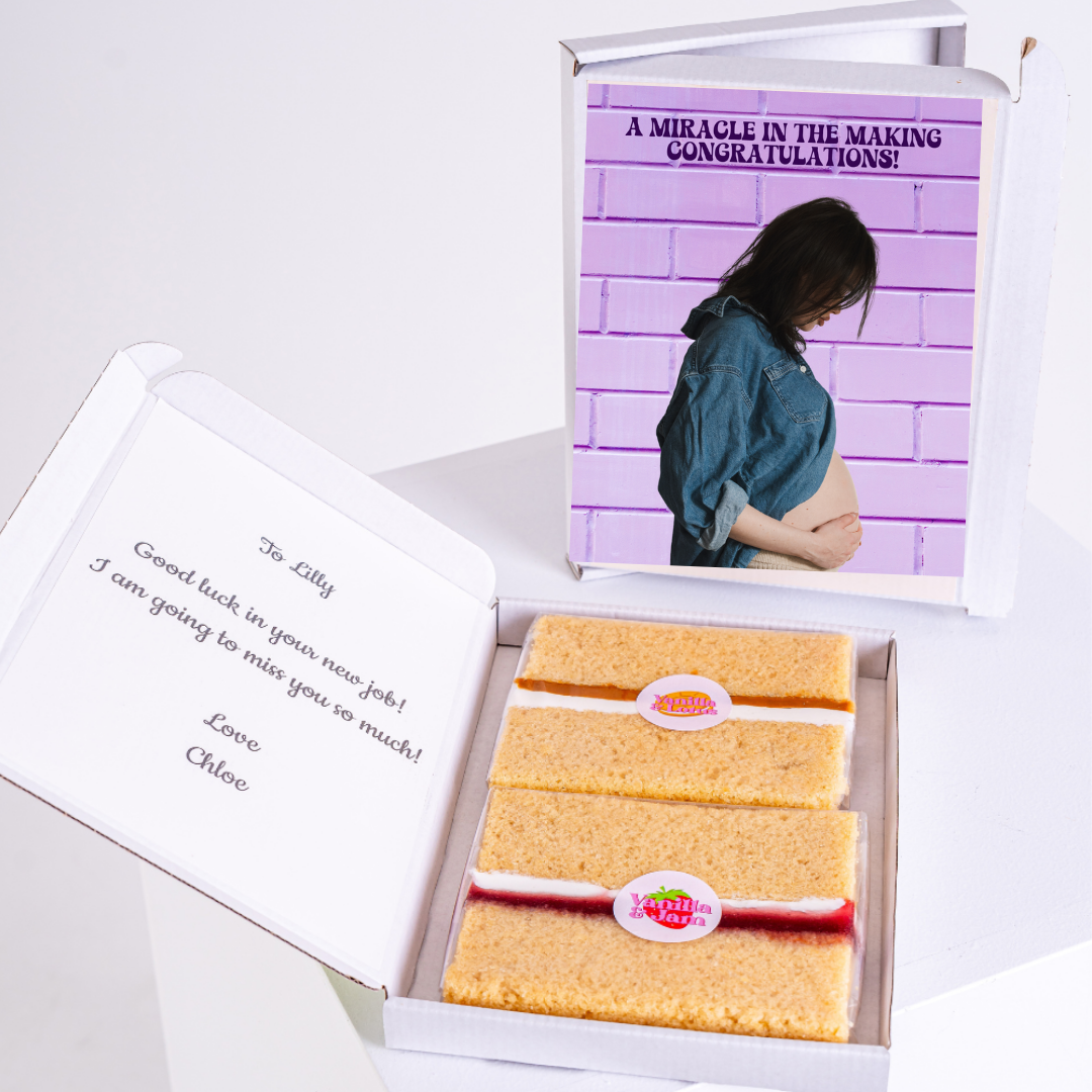 Gift box with cake and pregnancy announcement card, congratulating Lilly.