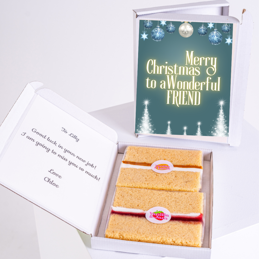 Cake slices in an open gift box with a Christmas card.