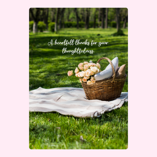picnic basket & flowers on a blanket in nature
