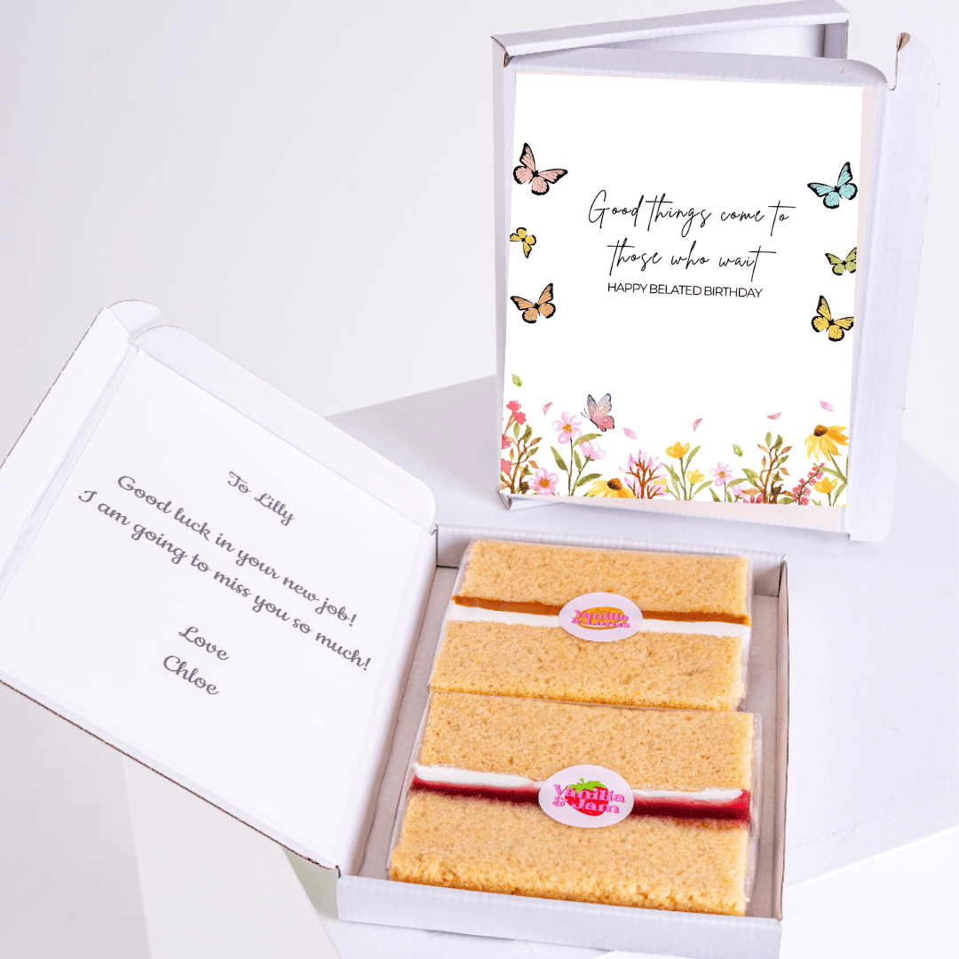 A belated birthday cake card with a heartfelt message and two slices of cake inside a gift box.