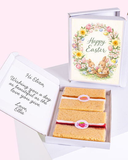 Happy Easter wreath with flowers and Easter eggs inside a gift box with cake slices.