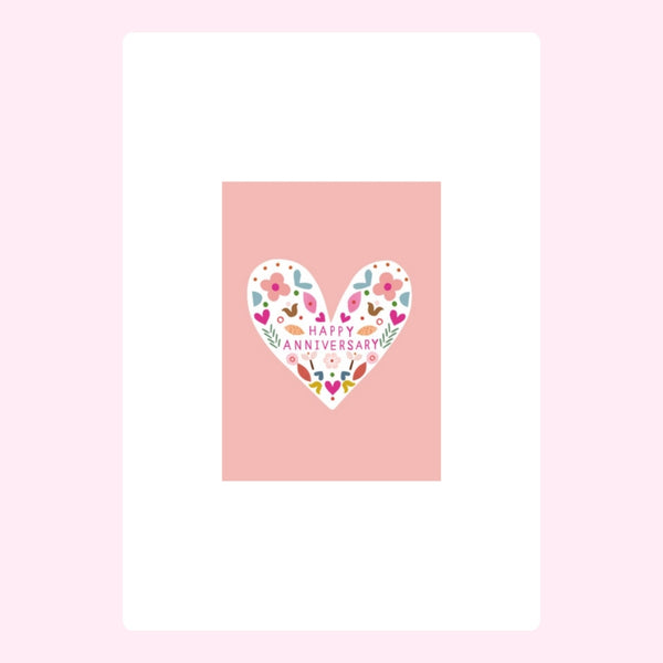Happy Anniversary floral heart design on soft pink background.