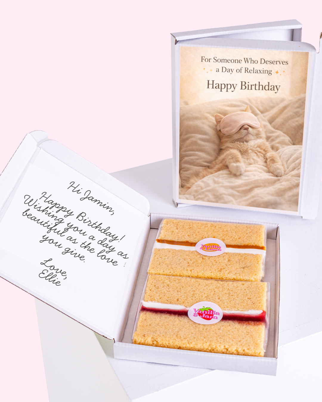 Cat wearing an eye mask on a "Happy Birthday" card, with vanilla biscuits inside
