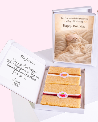 Cat wearing an eye mask on a "Happy Birthday" card, with vanilla biscuits inside