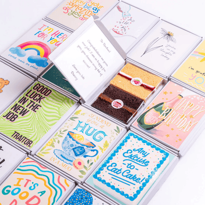 Assorted greeting cards and cake boxes, including Happy Birthday and Good...