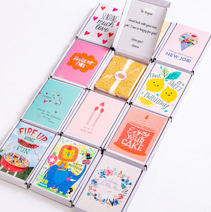 Gift boxes with birthday and well-wishing cards and cake.