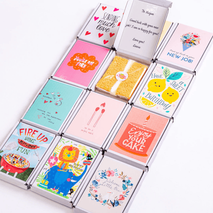 Assorted greeting cards in boxes, including Happy Birthday and New Job!