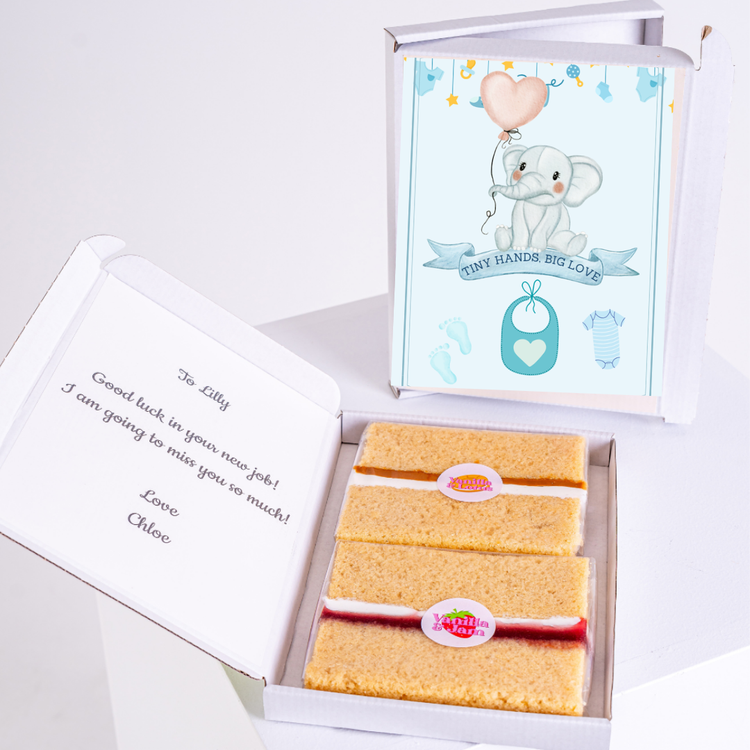 Baby shower gift box with cake and elephant design.