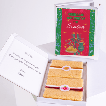 Gift box with Celebrate the Light of the Season card and cake.