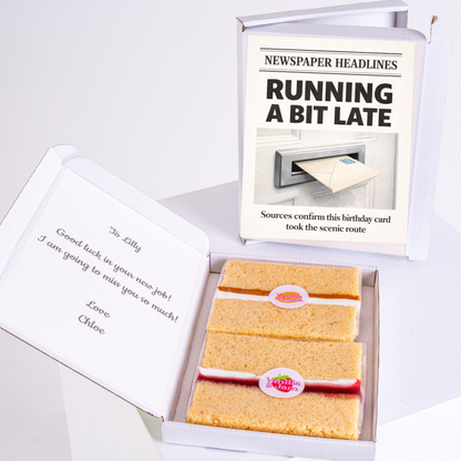 A humorous "Running a bit late" birthday card styled like a newspaper headline with the message "Sources confirm this birthday card took the scenic route" and personalized message with cake slices in a gift box.