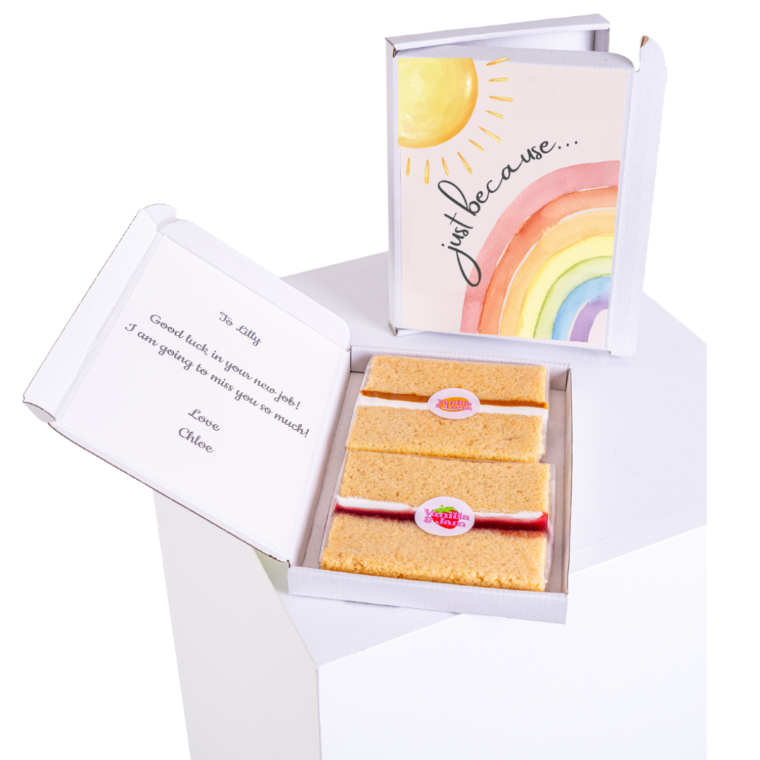 An open MailBakes rainbow cake card with two cake slices and a printed message