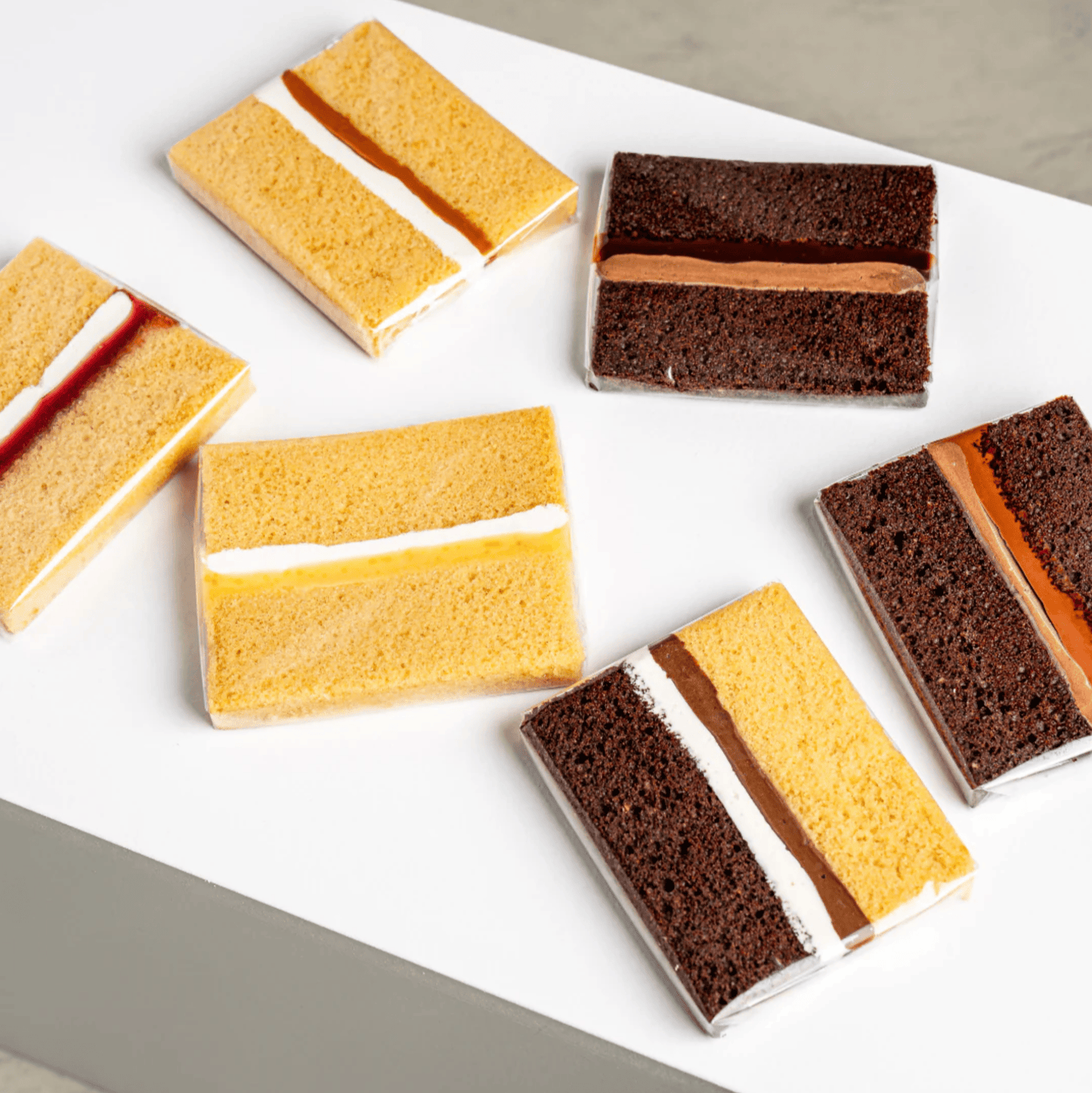 selection of mini cake slices with vanilla and chocolate sponge and cream filling
