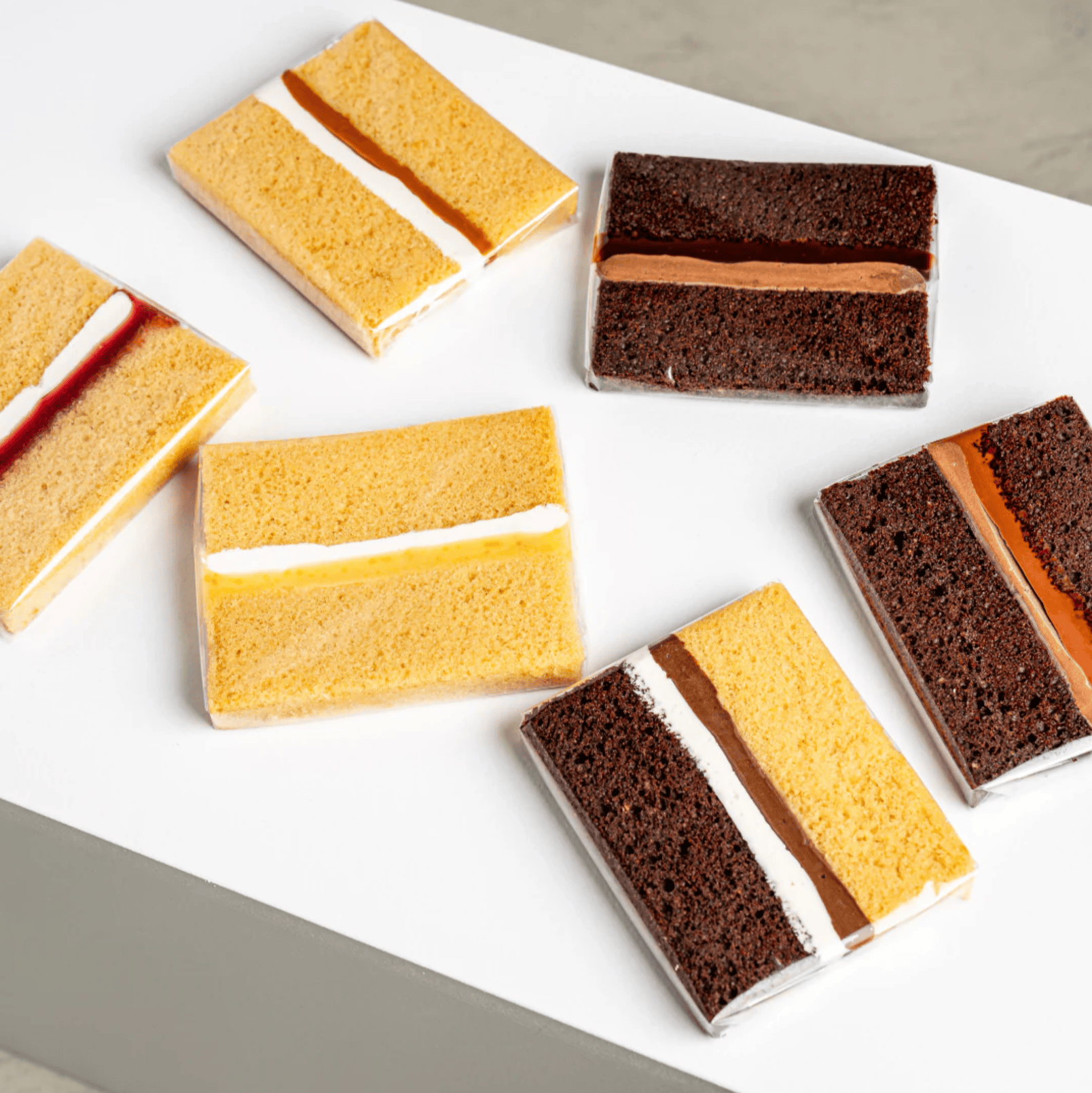 selection of mini cake slices with vanilla and chocolate sponge and cream filling