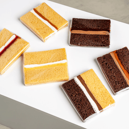 selection of mini cake slices with vanilla and chocolate sponge and cream filling
